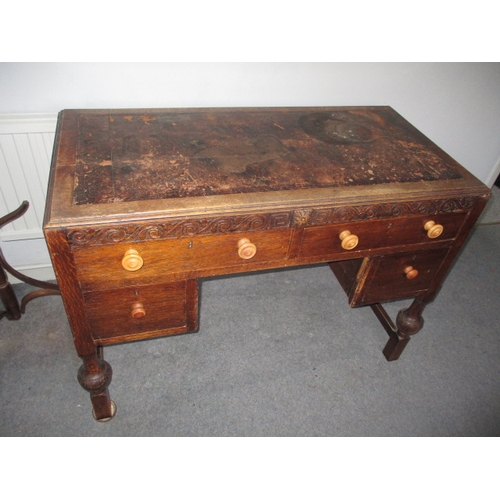 302 - A 1920s writing desk with drawers to base, in well used condition with use-related marks. Approximat... 