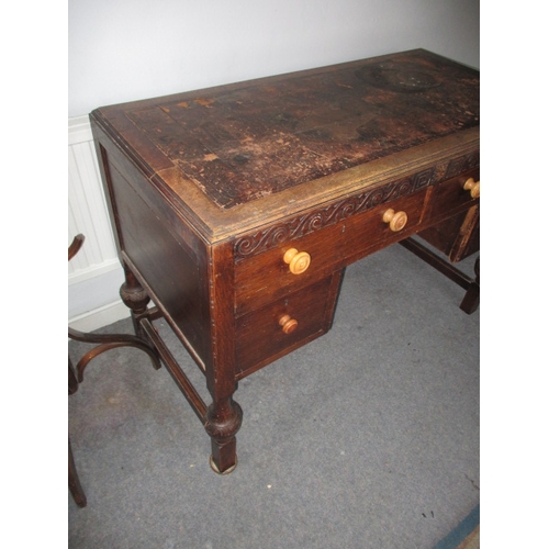 302 - A 1920s writing desk with drawers to base, in well used condition with use-related marks. Approximat... 