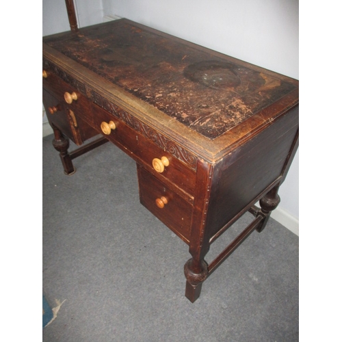 302 - A 1920s writing desk with drawers to base, in well used condition with use-related marks. Approximat... 