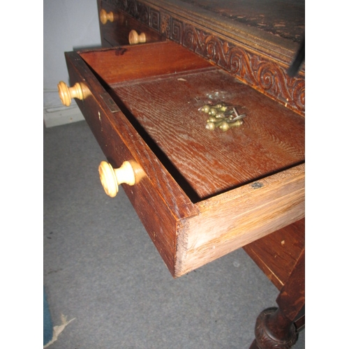 302 - A 1920s writing desk with drawers to base, in well used condition with use-related marks. Approximat... 