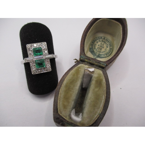 44 - A 1930s art deco platinum emerald and diamond cocktail ring, having rose cut diamonds and two approx... 