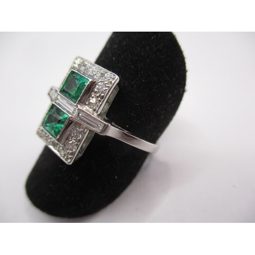 44 - A 1930s art deco platinum emerald and diamond cocktail ring, having rose cut diamonds and two approx... 