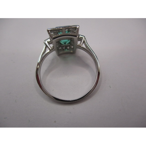 44 - A 1930s art deco platinum emerald and diamond cocktail ring, having rose cut diamonds and two approx... 