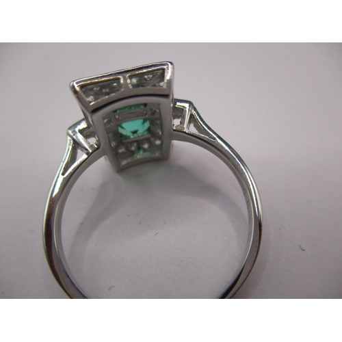 44 - A 1930s art deco platinum emerald and diamond cocktail ring, having rose cut diamonds and two approx... 