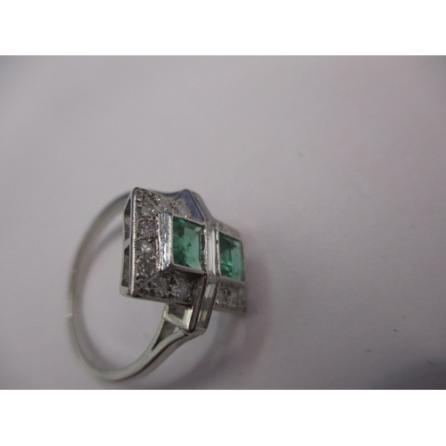 44 - A 1930s art deco platinum emerald and diamond cocktail ring, having rose cut diamonds and two approx... 