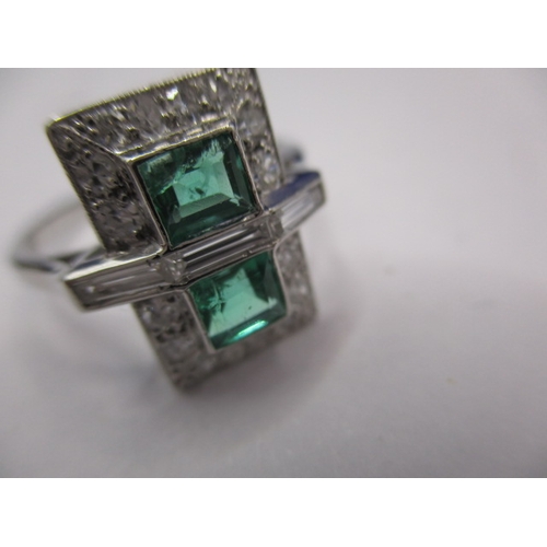 44 - A 1930s art deco platinum emerald and diamond cocktail ring, having rose cut diamonds and two approx... 