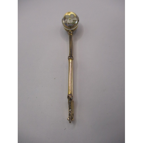 119 - A large antique 15ct gold stick pin with Essex crystal floral head and diamond set shaft, approx. le... 