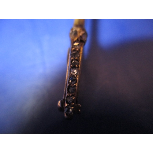 119 - A large antique 15ct gold stick pin with Essex crystal floral head and diamond set shaft, approx. le... 