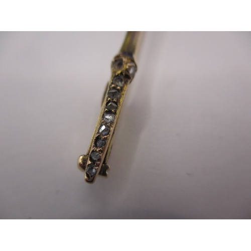 119 - A large antique 15ct gold stick pin with Essex crystal floral head and diamond set shaft, approx. le... 