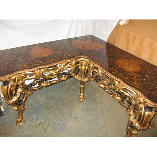A late 19th  early 20th Century ebonised and gilt wood inlaid corner table, having various woods and mother of pearl inlay, depicting birds and insects in stylized foliage. Prolific gilt scroll work to under tier. Some minor water damage. Approximate size 154cm x 154cm, depth 65cm, height 77cm