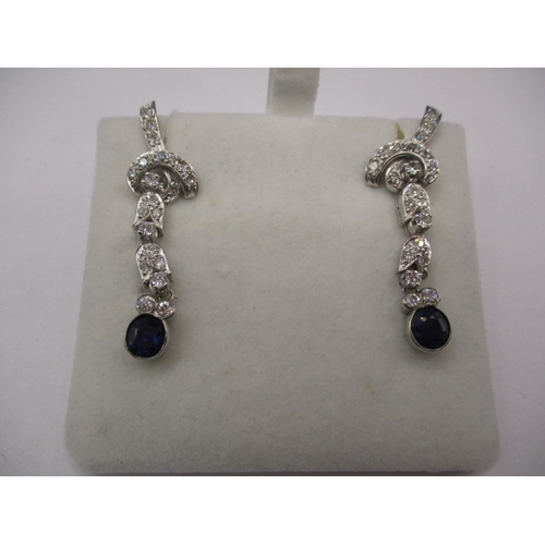 89 - A pair of period Art Deco 750 white gold diamond and sapphire drop earrings, having numerous diamond... 