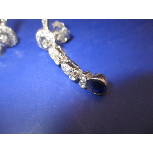 89 - A pair of period Art Deco 750 white gold diamond and sapphire drop earrings, having numerous diamond... 