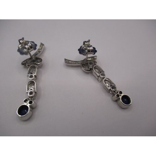 89 - A pair of period Art Deco 750 white gold diamond and sapphire drop earrings, having numerous diamond... 