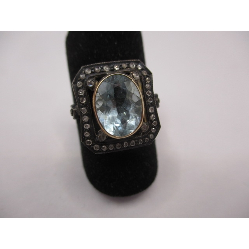 22 - An antique 15ct yellow gold and silver ring with central aquamarine surrounded by small old cut diam... 