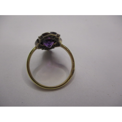 23 - A vintage 15ct yellow gold ring with central boat shaped amethyst surrounded by old cut diamonds, ap... 