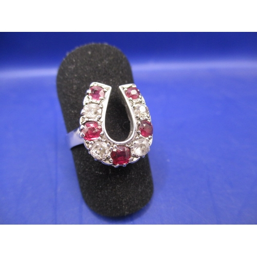 46 - An 18ct white gold horseshoe ring set with diamonds and natural rubies, approx. ring size ‘N+’ in go... 