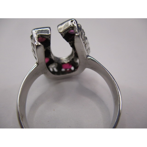 46 - An 18ct white gold horseshoe ring set with diamonds and natural rubies, approx. ring size ‘N+’ in go... 