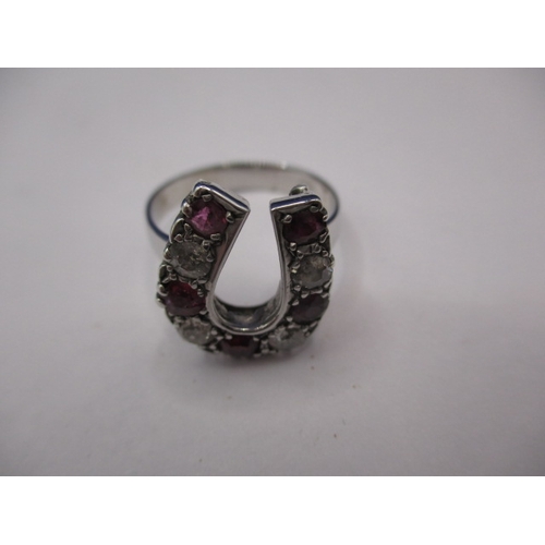 46 - An 18ct white gold horseshoe ring set with diamonds and natural rubies, approx. ring size ‘N+’ in go... 