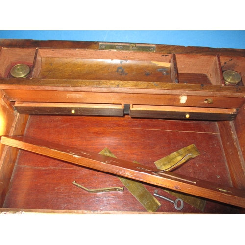 88 - An antique walnut brass bound writing box, having bottles and secret drawer, in need of restoration