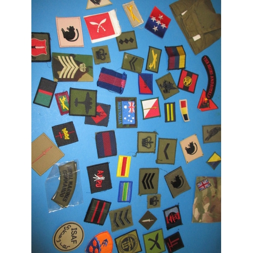 A parcel of vintage military cloth badges, various dates, all in pre-owned condition