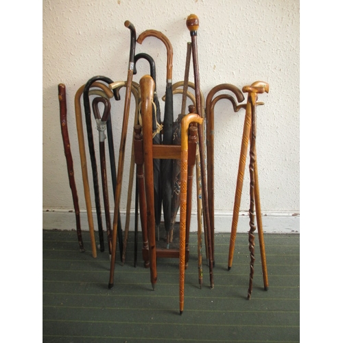 171 - A vintage hall stick stand, with numerous walking sticks and umbrellas, various sizes and ages, all ... 