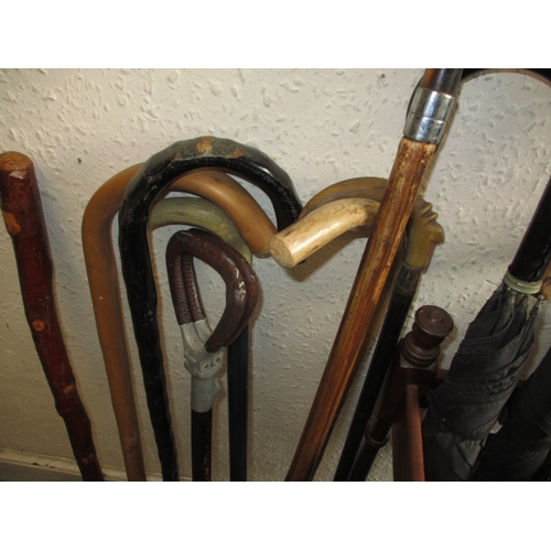 171 - A vintage hall stick stand, with numerous walking sticks and umbrellas, various sizes and ages, all ... 