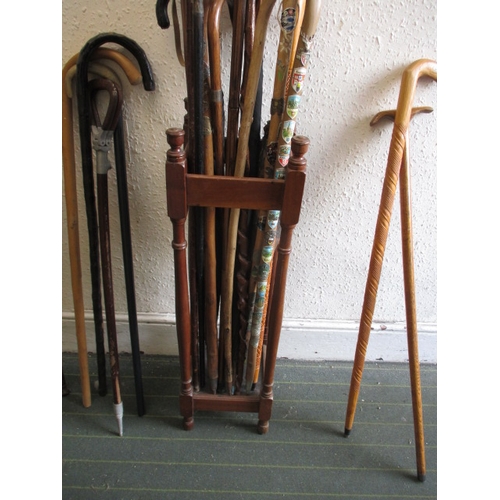 171 - A vintage hall stick stand, with numerous walking sticks and umbrellas, various sizes and ages, all ... 