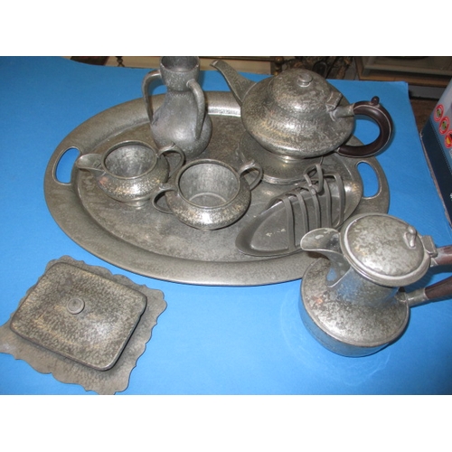 172 - A quantity of early 20th century hand hammered pewter items, to include a large tray, all in used co... 