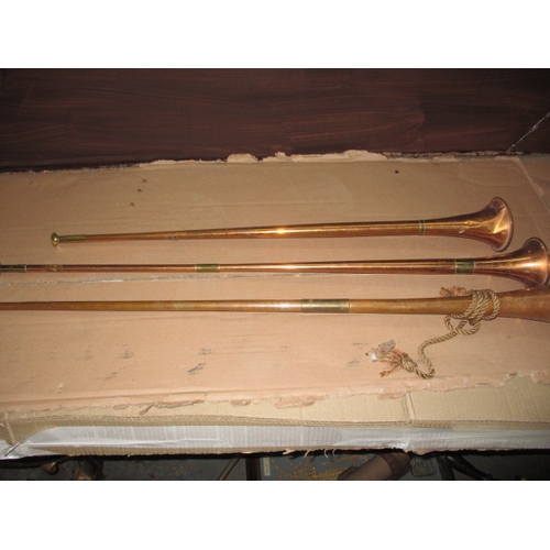 191 - Three copper post horns, some denting and general age-related marks, approx. length of longest 108cm