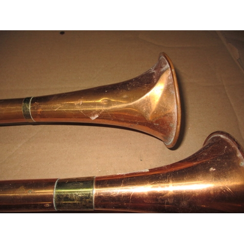 191 - Three copper post horns, some denting and general age-related marks, approx. length of longest 108cm