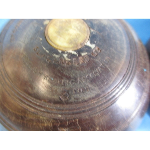 209 - Two lignum vitae wood bowls, in original carry bag, having use related marks