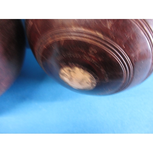 209 - Two lignum vitae wood bowls, in original carry bag, having use related marks