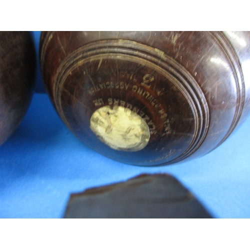 209 - Two lignum vitae wood bowls, in original carry bag, having use related marks