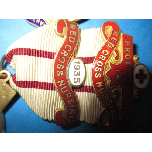 181 - A small collection of vintage Red Cross medals and associated items, some dated 1930s, all in good u... 