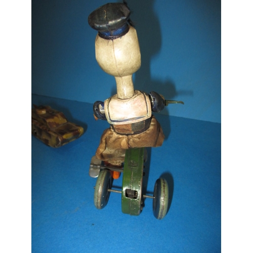 209 - A vintage clockwork cycling duck, a tank and a celluloid hanging mobile, all in play worn condition,... 