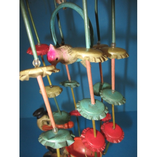 209 - A vintage clockwork cycling duck, a tank and a celluloid hanging mobile, all in play worn condition,... 