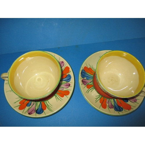 201 - Two original Clarice Cliff autumn crocus design cups and saucers, having hand written green crocus w... 