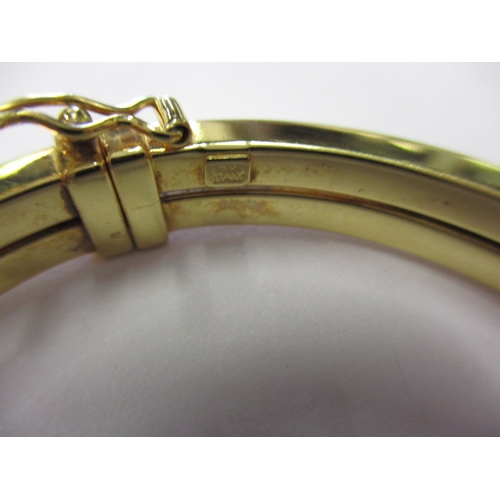 60 - A 9ct yellow gold bangle, with working  sprung closure and safety catch, approx. gross weight 9.3g i... 