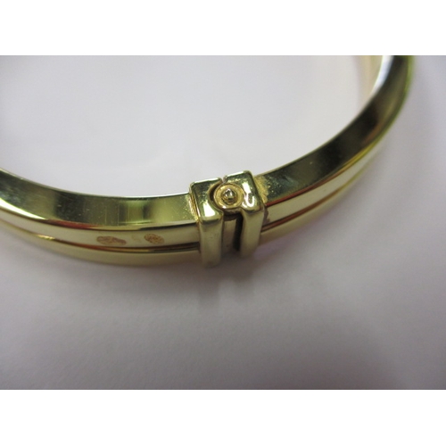 60 - A 9ct yellow gold bangle, with working  sprung closure and safety catch, approx. gross weight 9.3g i... 