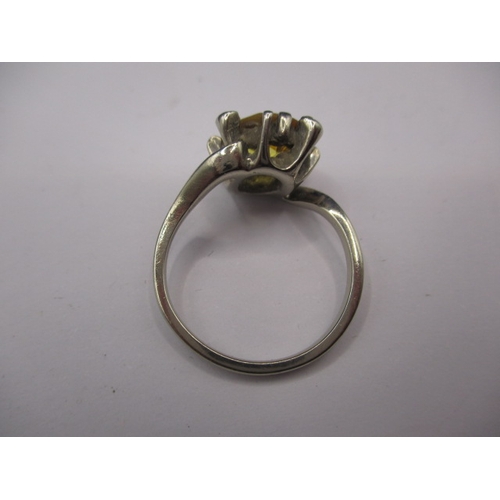 20 - An unmarked white gold ring, tested as 9ct with large central yellow stone, electronic test indicate... 