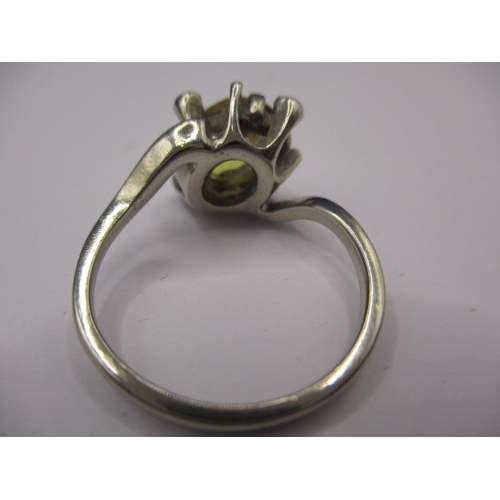 20 - An unmarked white gold ring, tested as 9ct with large central yellow stone, electronic test indicate... 