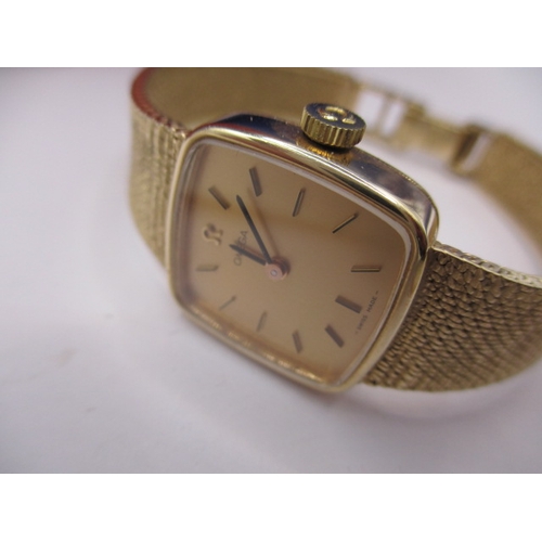 113 - A vintage 9ct gold omega watch, having 9ct gold integral strap, in current working order with a box ... 