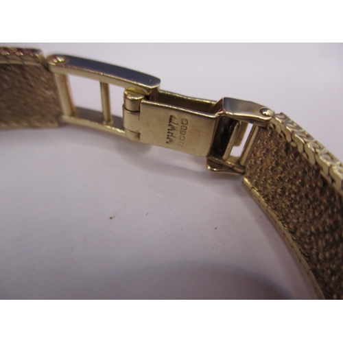 113 - A vintage 9ct gold omega watch, having 9ct gold integral strap, in current working order with a box ... 