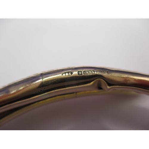 62 - A vintage yellow gold forearm bangle in the shape of a coiled snake, approx. weight 13.45g, having s... 