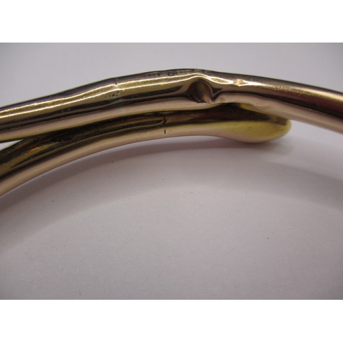 62 - A vintage yellow gold forearm bangle in the shape of a coiled snake, approx. weight 13.45g, having s... 