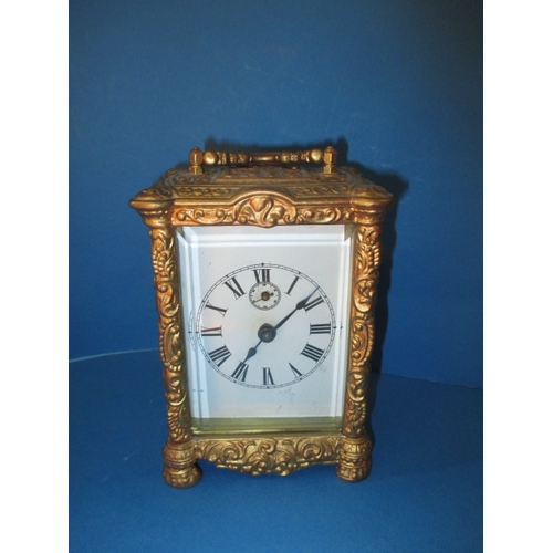 232 - A vintage gilt metal carriage clock, striking on a bell, age-related marks and no key so not tested ... 