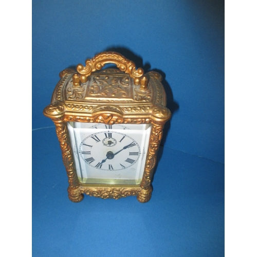 232 - A vintage gilt metal carriage clock, striking on a bell, age-related marks and no key so not tested ... 