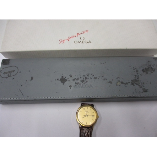 115 - A 1990s Omega 18ct gold cased watch, with date window, in unused condition and still retaining prote... 