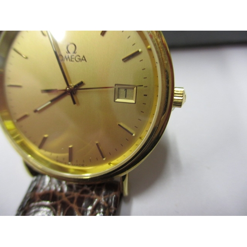 115 - A 1990s Omega 18ct gold cased watch, with date window, in unused condition and still retaining prote... 