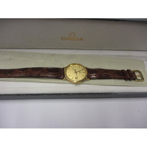 115 - A 1990s Omega 18ct gold cased watch, with date window, in unused condition and still retaining prote... 